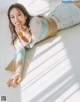 A woman laying on the floor with her hand on her chin.